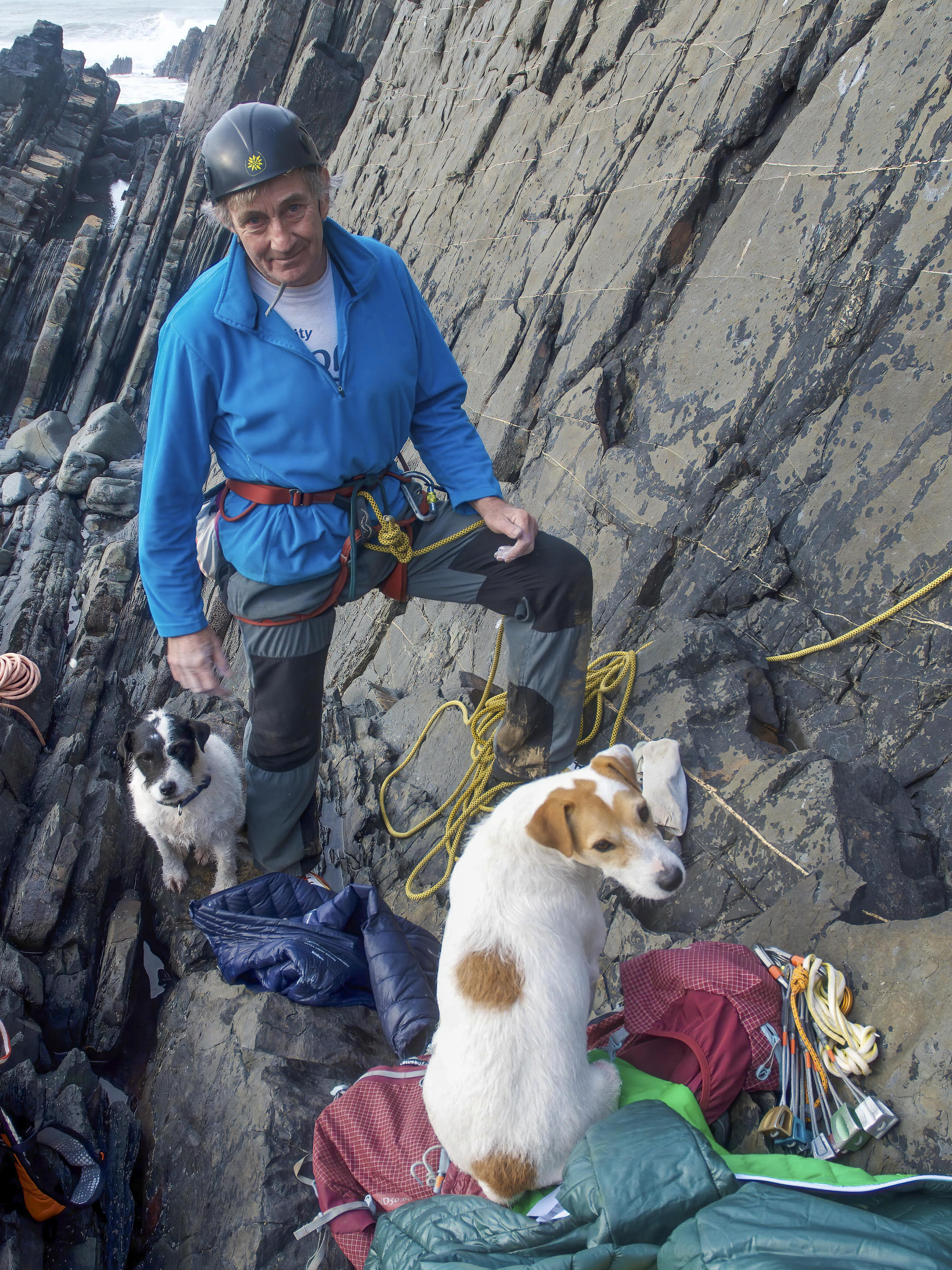 A photograph of Iain Peters climbing with his dogs